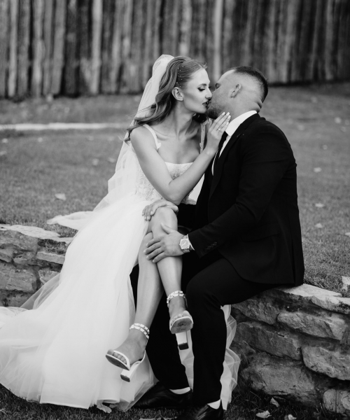 man-woman-are-sitting-stone-wall-woman-is-kissing